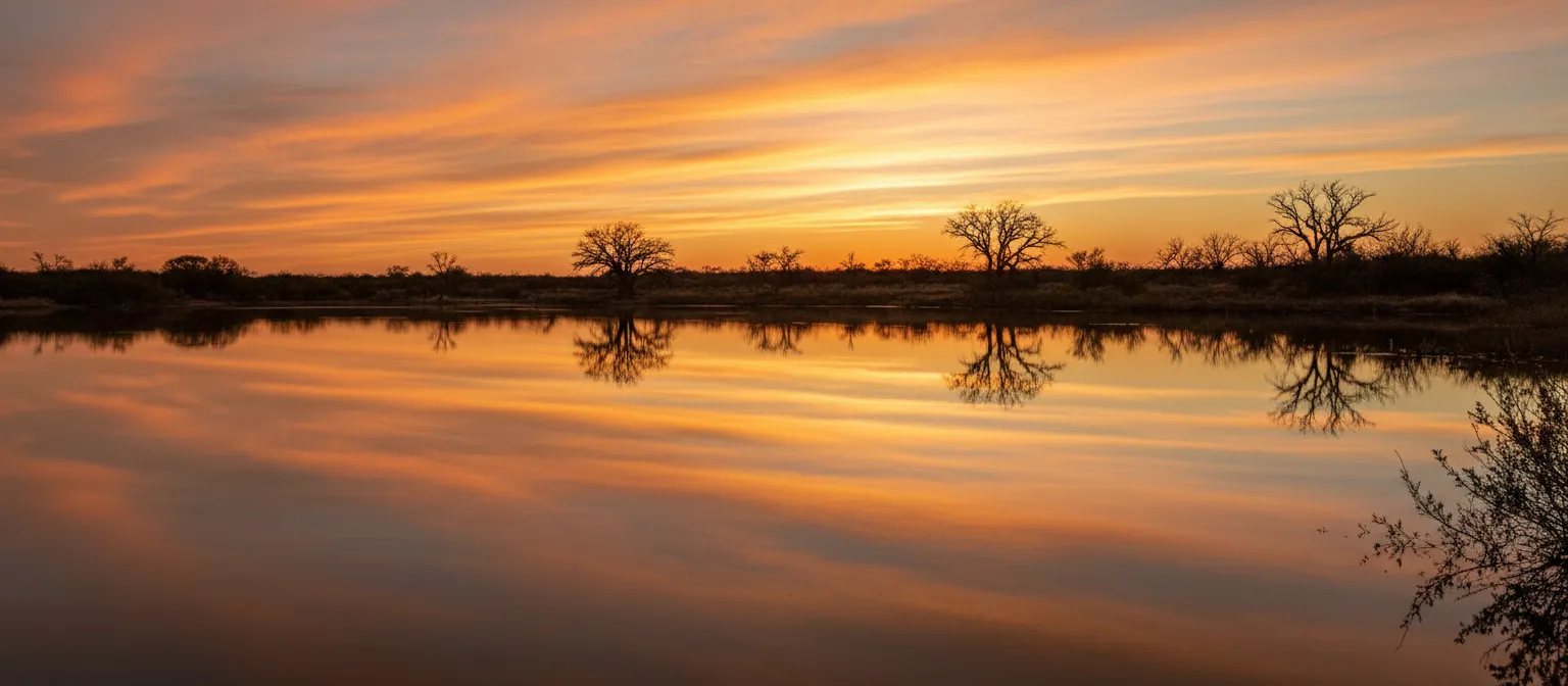 Golden hour sunset over still water in South Texas